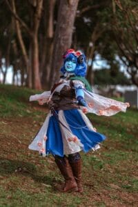 Jester Cosplay, Makeup, Clothing Alterations and Wig by @Cadavyx (Twitter, Instagram) Base Skirt and Vest by @Grubmeat (Instagram) || Choker by @MagpiesOddities (Twitter, Instagram) || Tights by @Tejajamilla (Instagram) || Capelet by @Techndolly (Etsy) || Photography by @Sororaphoto (Instagram)