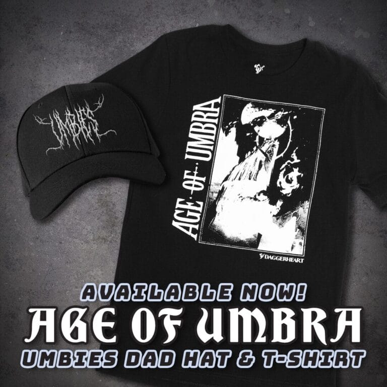 Black T-shirt with a white graphic and diagonal 'AGE OF UMBRA' text, paired with a black logo-cap on a dark background; promo banner below.